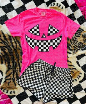 Checkered Jack o lantern on neon pink graphic tee